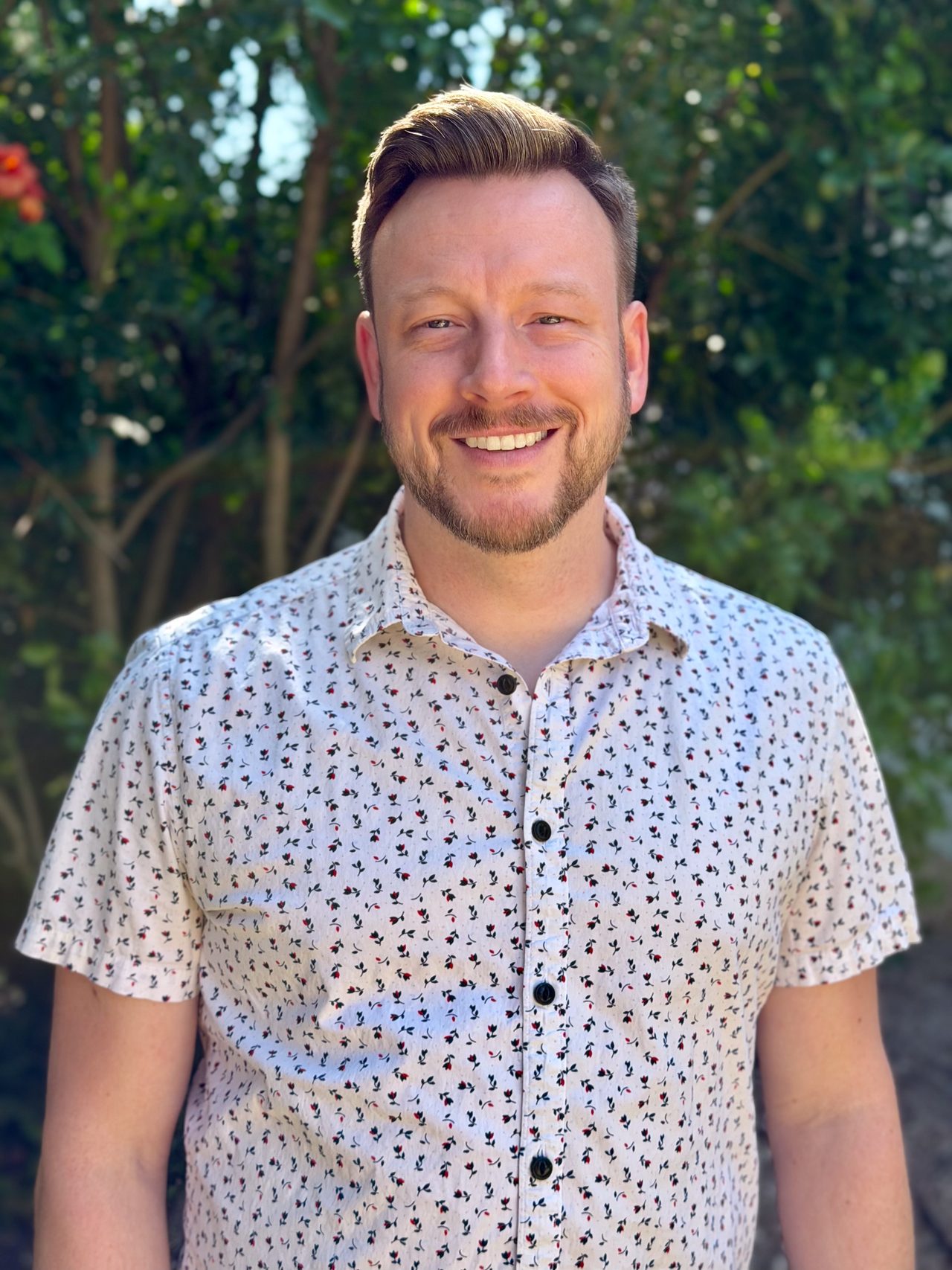 Dennis Hadley smiling outdoors